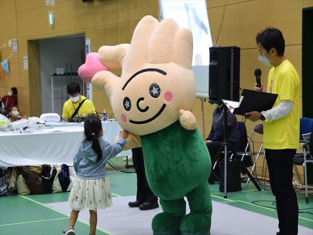 福祉祭り(女の子と交流するひらりちゃんの様子)